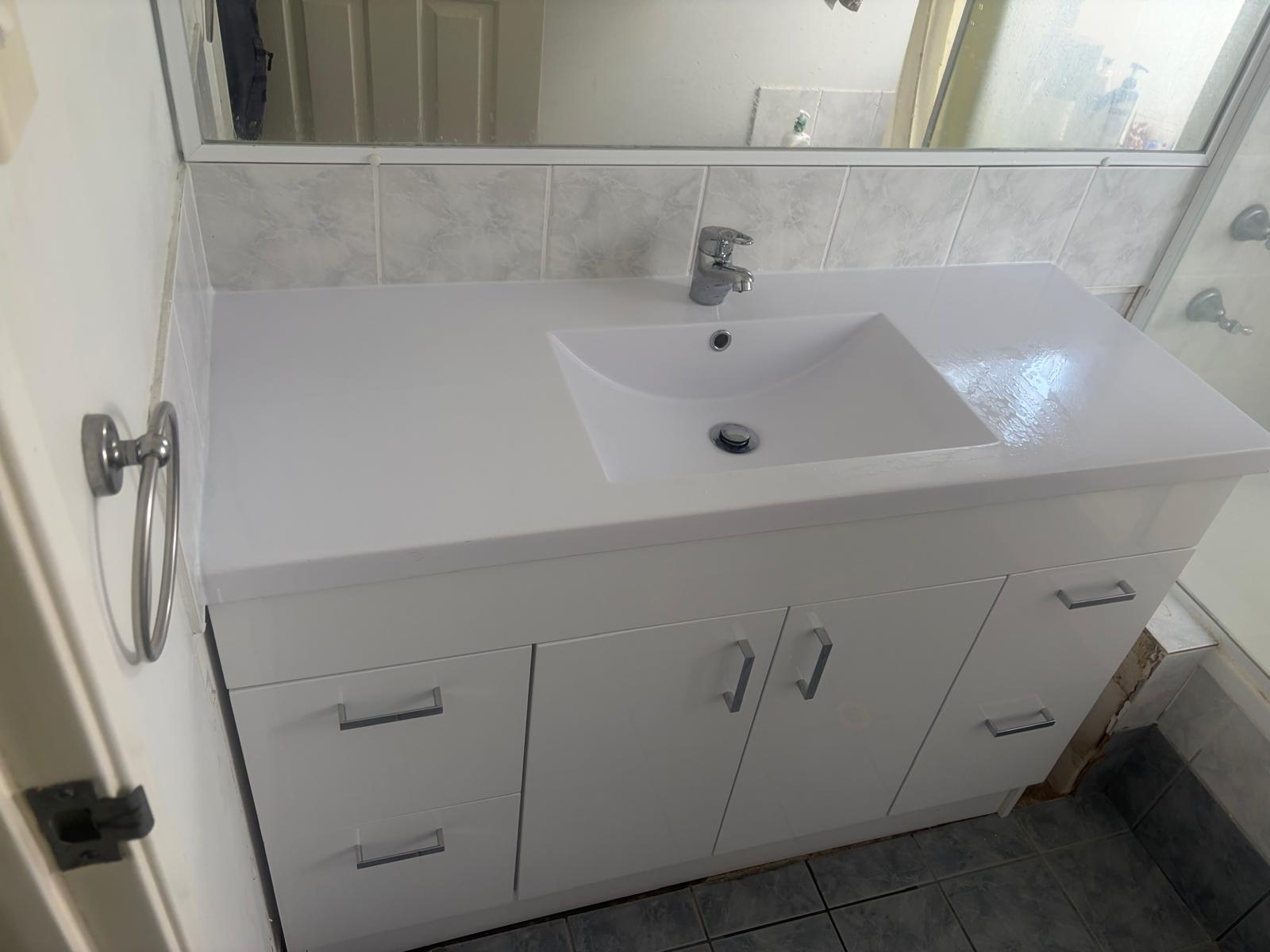 New, clean bathroom vanity after replacement